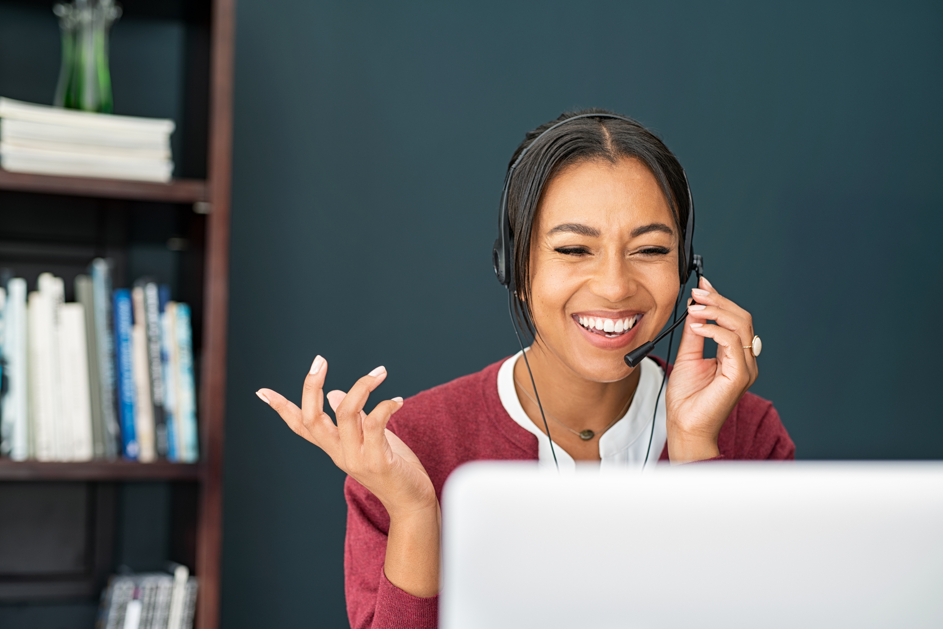 Smiling business woman using headset.